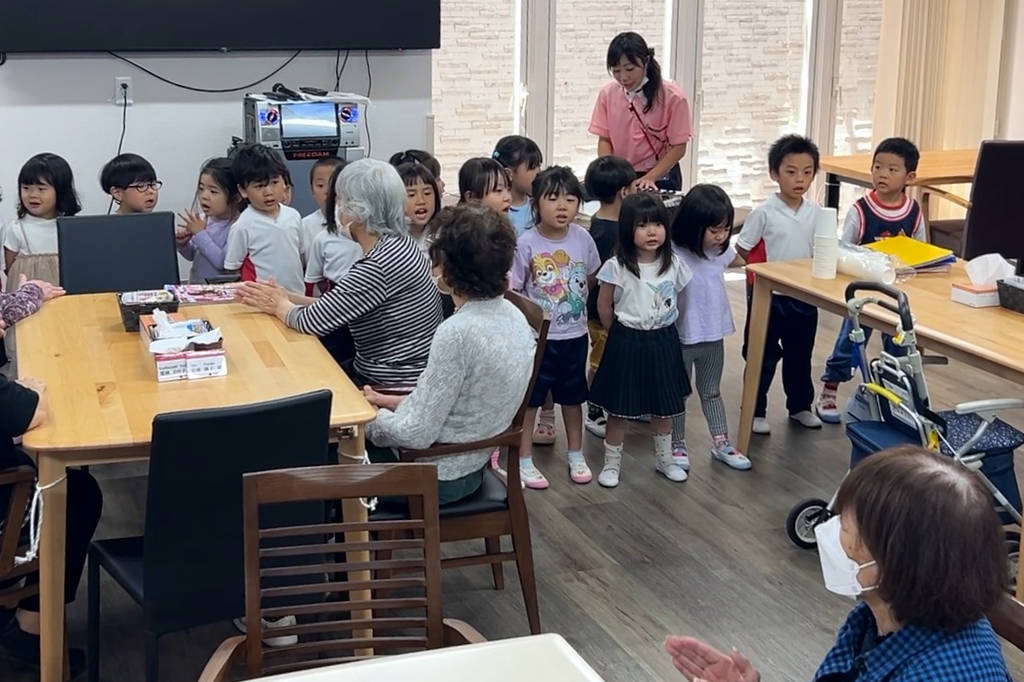 Children at A-Cube singing a song to the seniors